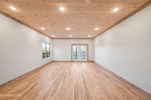 unfurnished room featuring light wood-type flooring, ornamental molding, french doors, wooden ceiling, and baseboards