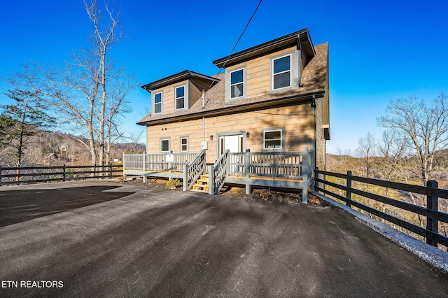 view of front of home featuring fence