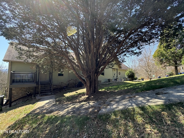 view of side of home featuring a lawn