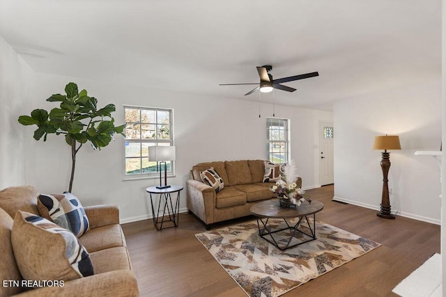 living room with a wealth of natural light, baseboards, wood finished floors, and a ceiling fan