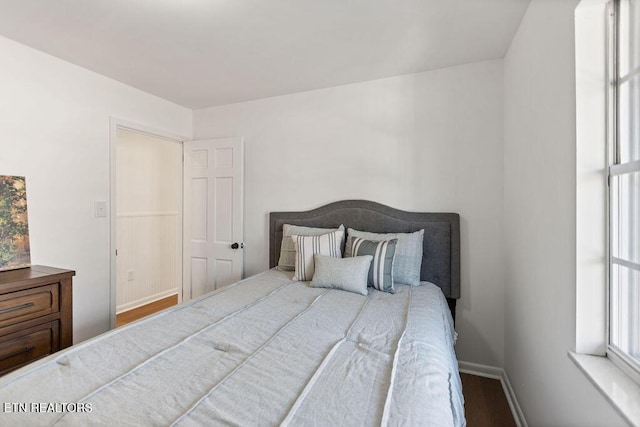 bedroom featuring wood finished floors and baseboards