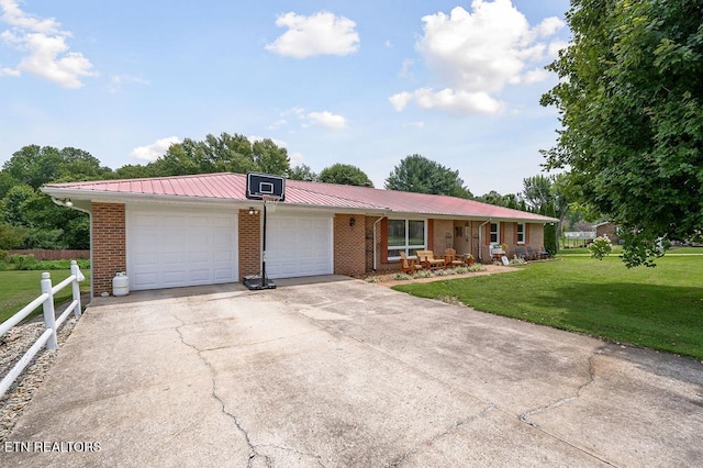 ranch-style house featuring driveway, a front lawn, a garage, brick siding, and metal roof