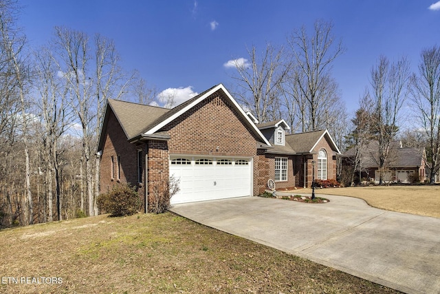 view of front of property with concrete driveway, an attached garage, brick siding, and a front yard