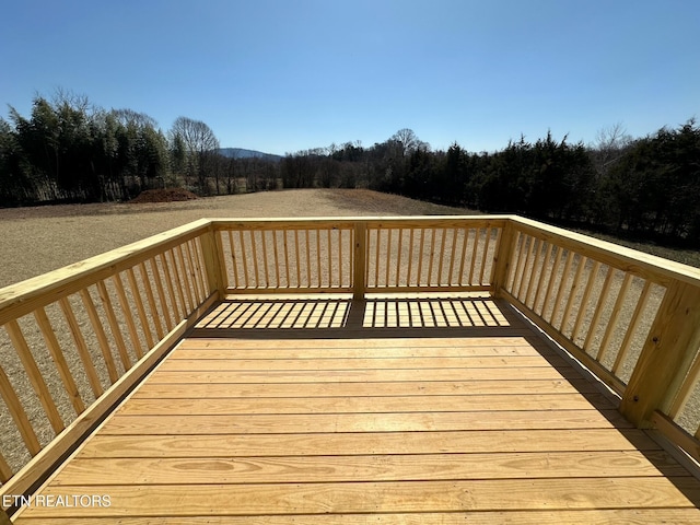 wooden terrace with a view of trees