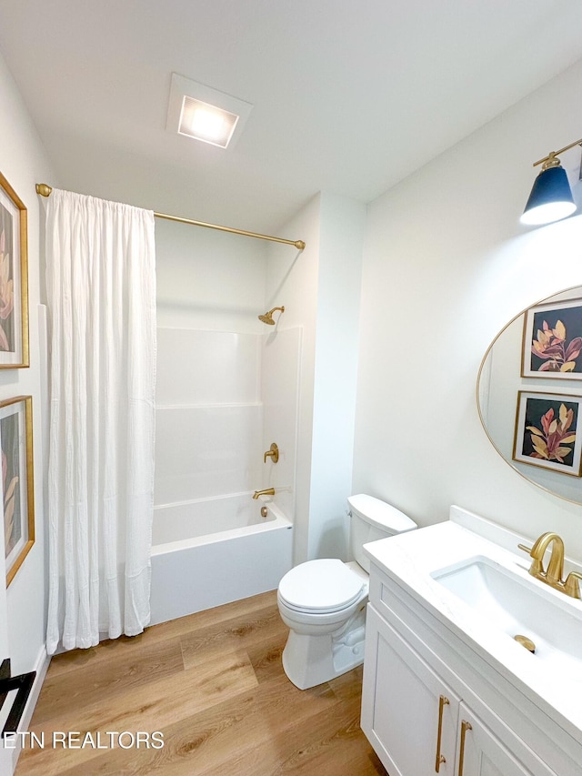 bathroom with vanity, shower / bathtub combination with curtain, toilet, and wood finished floors