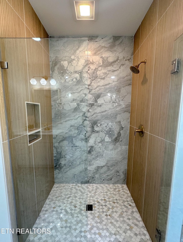 bathroom featuring visible vents and tiled shower