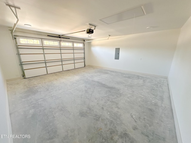 garage featuring electric panel, a garage door opener, and baseboards