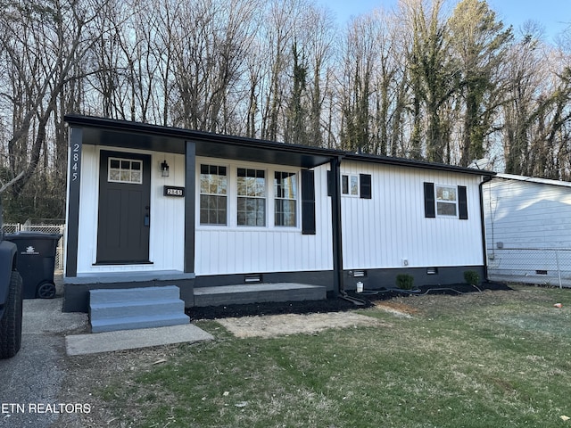 view of front of property with a front yard, fence, and crawl space