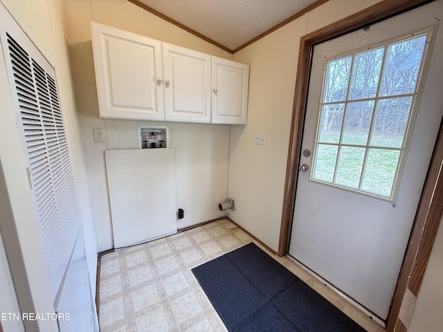 laundry room featuring hookup for a washing machine, light floors, cabinet space, a heating unit, and a textured ceiling