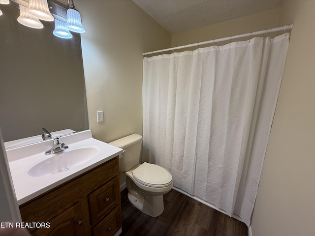 full bath featuring toilet, vanity, and wood finished floors