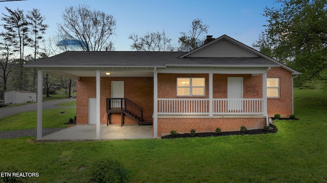 108 Burke St, Pennington Gap, VA 24277 - view of front of property with brick siding, a front lawn, and covered porch