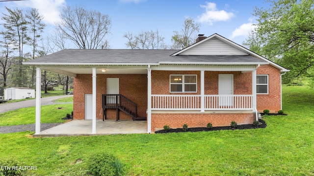 108 Burke St, Pennington Gap, VA 24277 - view of front of home with covered porch, a carport, a front lawn, brick siding, and a chimney