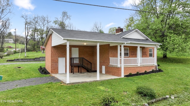 108 Burke St, Pennington Gap, VA 24277 - back of house with a chimney, covered porch, a yard, and brick siding