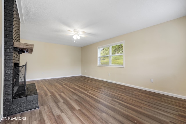108 Burke St, Pennington Gap, VA 24277 - unfurnished living room featuring a brick fireplace, ceiling fan, baseboards, and wood finished floors