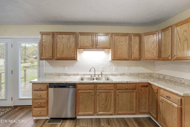 108 Burke St, Pennington Gap, VA 24277 - kitchen with decorative backsplash, wood finished floors, stainless steel dishwasher, and a sink