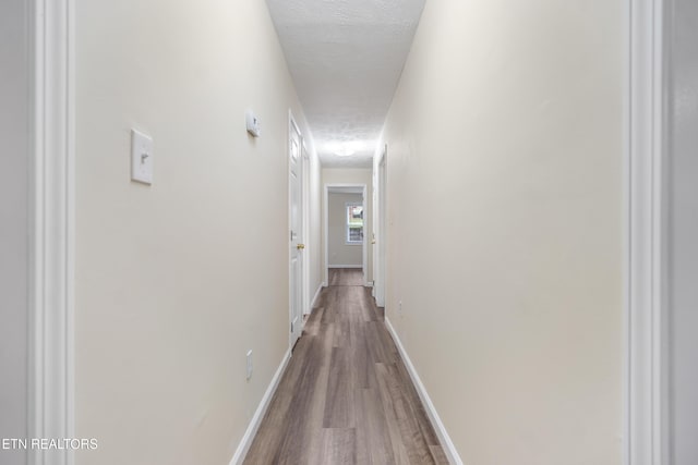 108 Burke St, Pennington Gap, VA 24277 - hall with a textured ceiling, wood finished floors, and baseboards