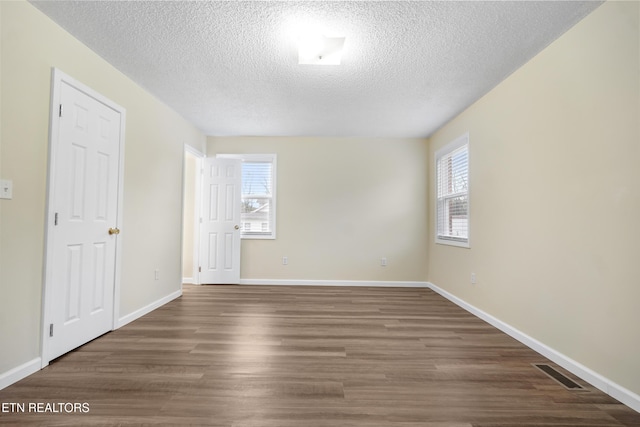 108 Burke St, Pennington Gap, VA 24277 - empty room with a textured ceiling, wood finished floors, baseboards, and visible vents