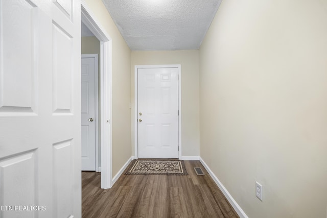 108 Burke St, Pennington Gap, VA 24277 - doorway to outside with a textured ceiling, baseboards, dark wood finished floors, and visible vents