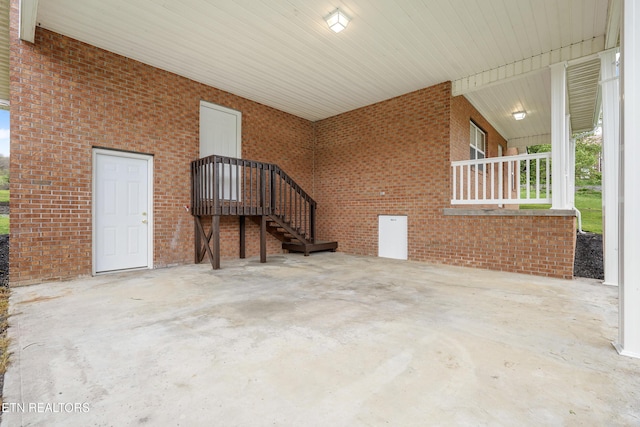 108 Burke St, Pennington Gap, VA 24277 - unfurnished living room featuring concrete floors and brick wall