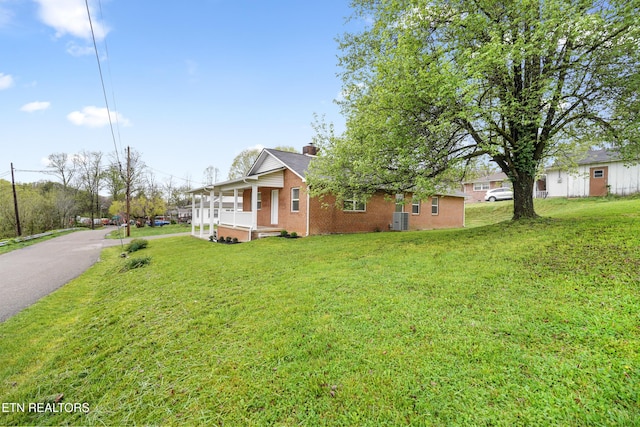 108 Burke St, Pennington Gap, VA 24277 - exterior space featuring a porch, a chimney, a front yard, and brick siding