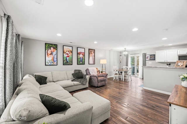 living area with an inviting chandelier, recessed lighting, dark wood-style flooring, and baseboards