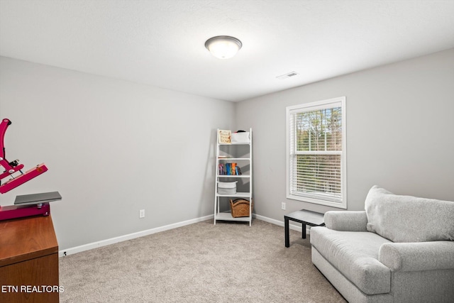 sitting room featuring carpet flooring, baseboards, and visible vents