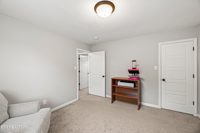 sitting room with light carpet and baseboards