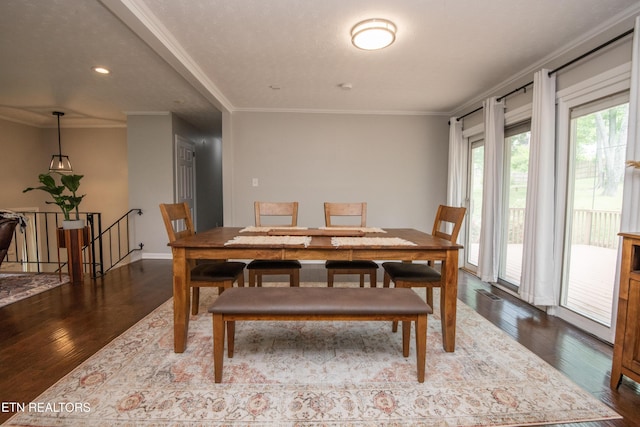 dining room featuring ornamental molding, baseboards, recessed lighting, and dark wood finished floors