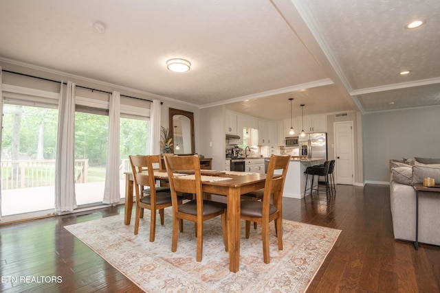dining room featuring baseboards, recessed lighting, dark wood finished floors, and crown molding
