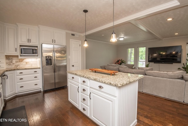 kitchen with open floor plan, stainless steel appliances, dark wood finished floors, and a center island