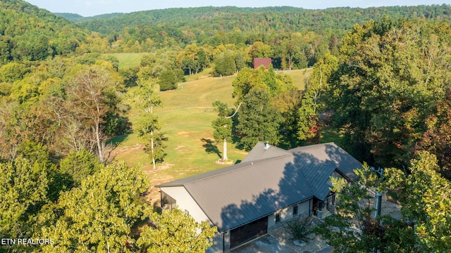 birds eye view of property with a view of trees