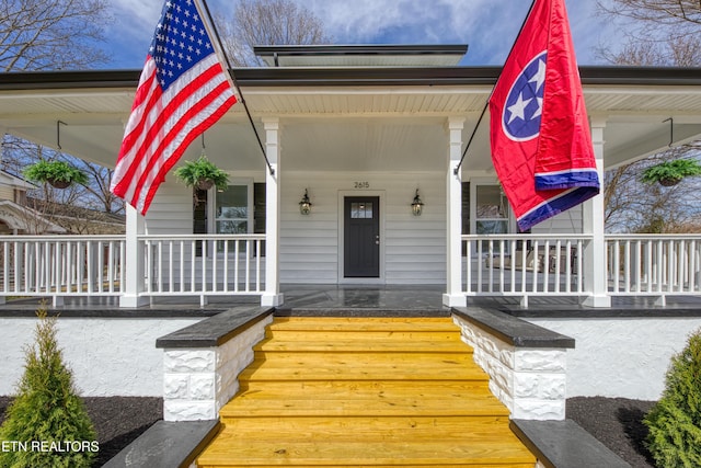 view of exterior entry featuring a porch