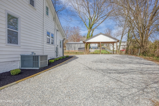 view of home's exterior featuring cooling unit and driveway