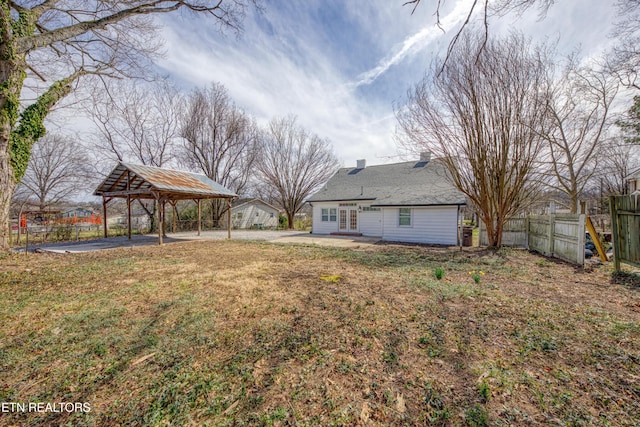 view of yard with a detached carport, a patio area, and fence