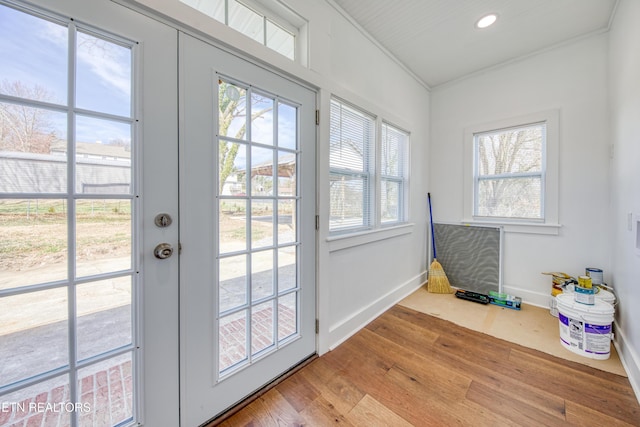 doorway with baseboards, recessed lighting, ornamental molding, hardwood / wood-style flooring, and french doors