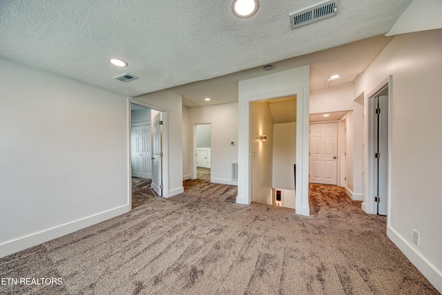 unfurnished bedroom featuring visible vents, baseboards, carpet flooring, recessed lighting, and a textured ceiling