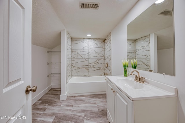 bathroom featuring washtub / shower combination, visible vents, baseboards, and vanity