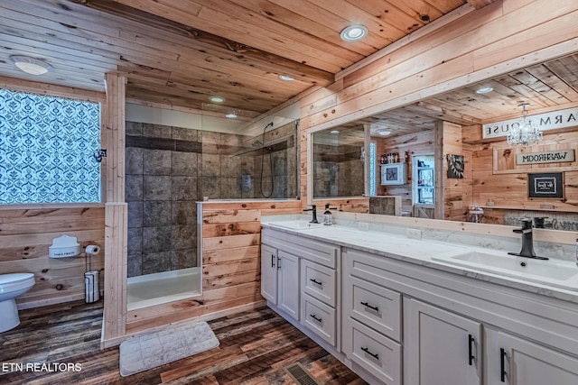 bathroom featuring wood walls, wooden ceiling, tiled shower, and a sink