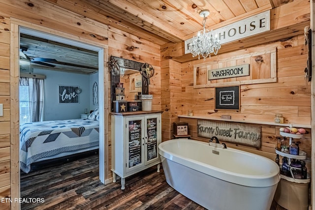 full bathroom with wooden walls, wood finished floors, wooden ceiling, a freestanding tub, and ensuite bath