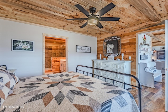 bedroom featuring wood finished floors, wooden walls, wooden ceiling, and ensuite bathroom