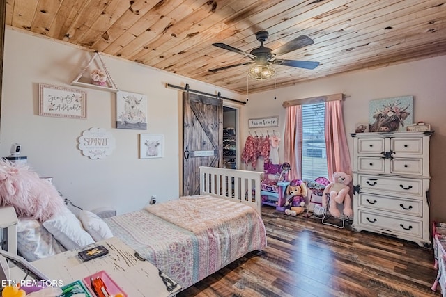 bedroom featuring a barn door, a ceiling fan, wood finished floors, and wooden ceiling