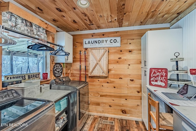 kitchen featuring visible vents, wood ceiling, wood finished floors, white cabinetry, and separate washer and dryer