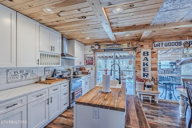 kitchen with double oven range, wooden counters, wall chimney exhaust hood, and wooden ceiling