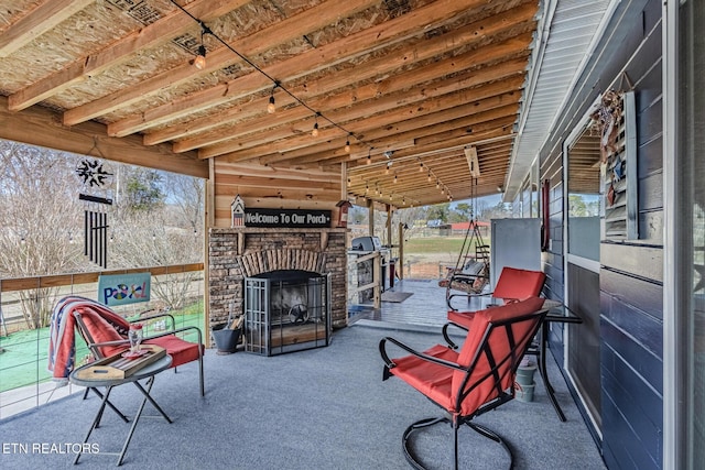 view of patio / terrace featuring an outdoor brick fireplace