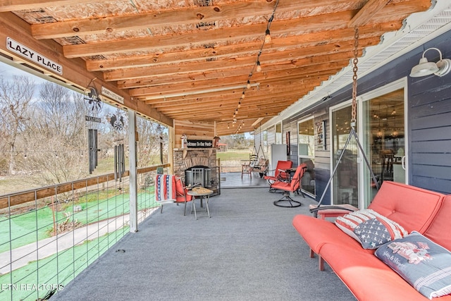 view of patio / terrace featuring an outdoor stone fireplace