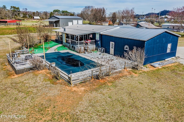 back of property with a lawn and metal roof