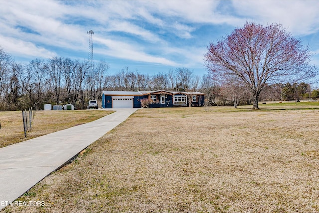 ranch-style home with a front lawn, an attached garage, and driveway