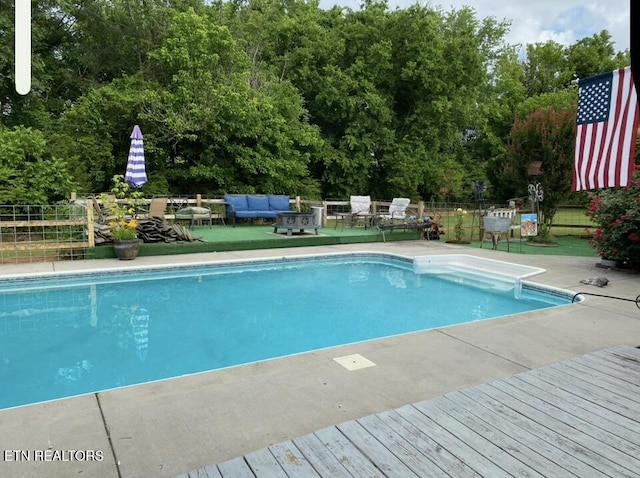 view of pool featuring a fenced in pool, a patio area, outdoor lounge area, and fence