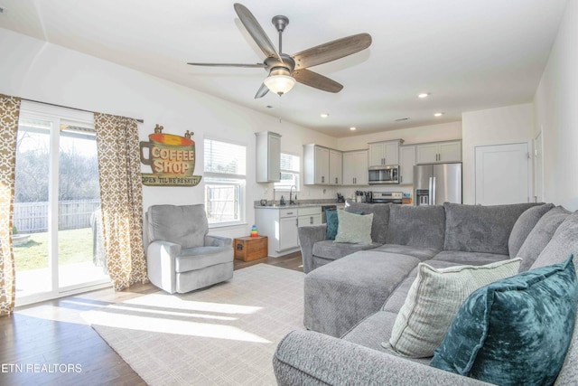 living room featuring recessed lighting, ceiling fan, and wood finished floors