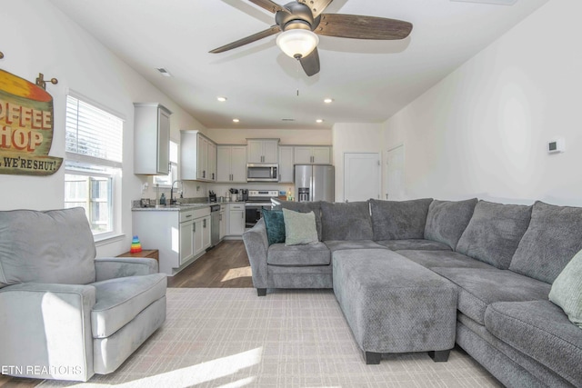 living room featuring recessed lighting, light wood-style flooring, and ceiling fan